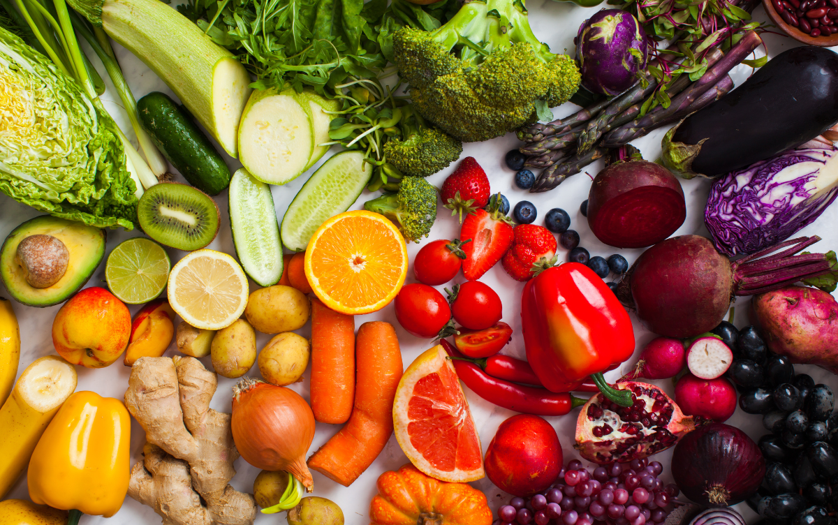 A colorful flat lay of vitamin-rich fruits and supplements.
